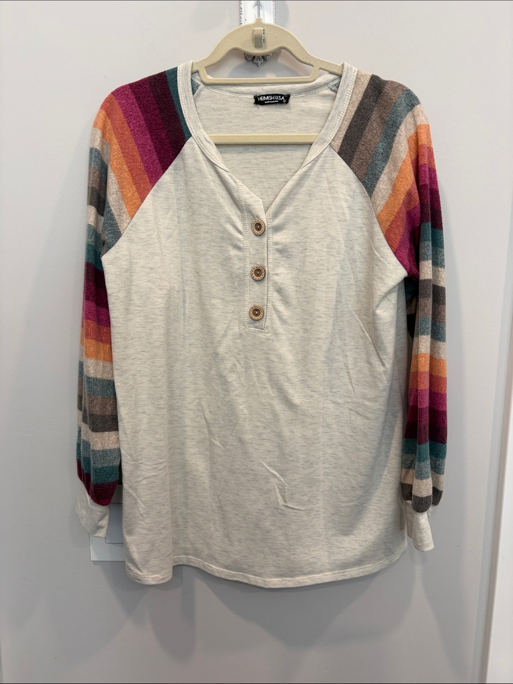 HEIMISH USA Cream Henley with Rainbow Striped Raglan Sleeves